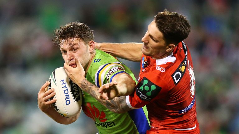 CANBERRA - JULY 14 2017:  Elliot Whitehead of the Raiders is tackled by Gareth Widdop of the Dragons during the round 19 NRL match