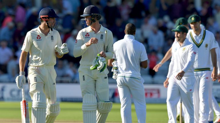 England's Alastair Cook (L) and Keaton Jennings (2nd L) leave the field at the close of play on day three of the second Test v South Africa at Trent Bridge