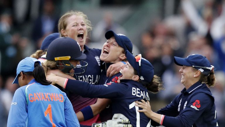 England's Anya Shrubsole (C) celebrates as she takes the wicket of India's Rajeshwari Gayakwad (L) to win the ICC Women's World Cup cricket final