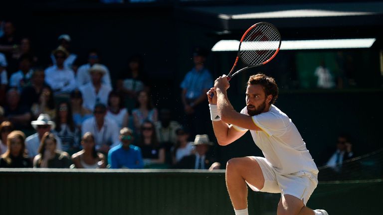 Latvia's Ernests Gulbis returns against Serbia's Novak Djokovic during their men's singles third round match on the sixth day of the 2017 Wimbledon Champio