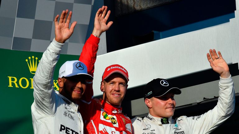 Sebastian Vettel celebrates his win at the Australian GP with Lewis Hamilton and Valtteri Baottas