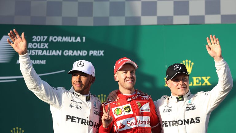 Sebastian Vettel celebrates his win at the Australian GP with Lewis Hamilton and Valtteri Baottas