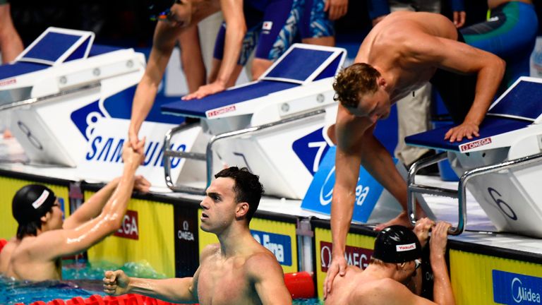 Britain's James Guy and his teammates react after competing in the men's 4x200m freestyle relay final
