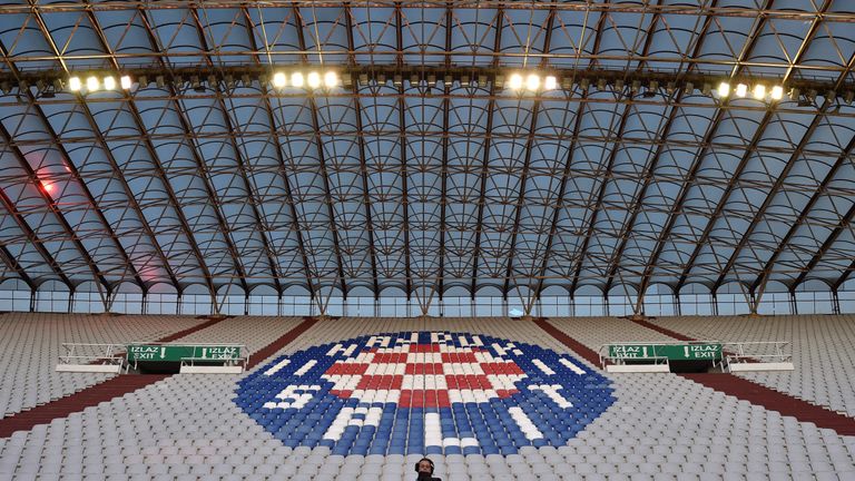 A camera man is seen in the empty stands ahead of the Euro 2016 qualifying football match between Croatia and Italy at Poljud stadium in Split on June 12, 