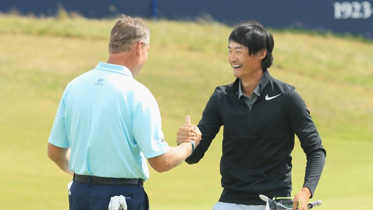 SOUTHPORT, ENGLAND - JULY 23:  Haotong Li of China (R) with Ernie Els of South Africa on the 18th green during the final round of the 146th Open Championsh