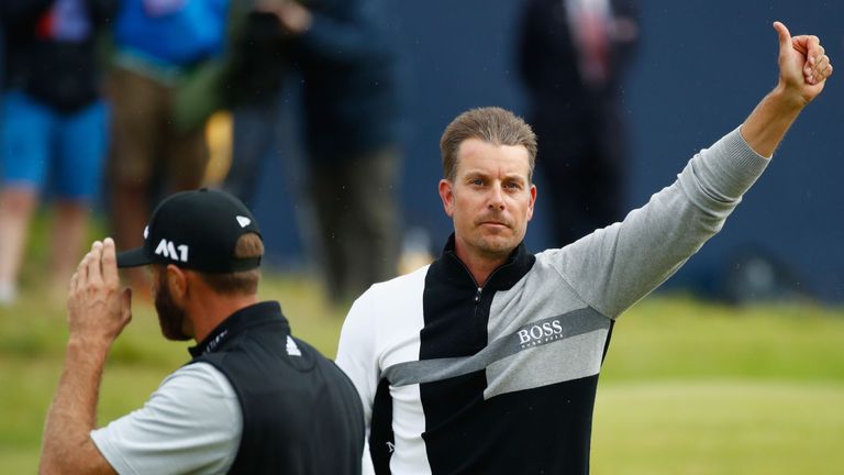 Henrik Stenson of Sweden and Dustin Johnson of the United States acknowledge the crowd on the 18th hole