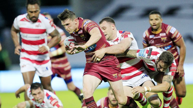 Huddersfield's Lee Gaskell tackled by Leigh's Sam Hopkins and Ben Crooks