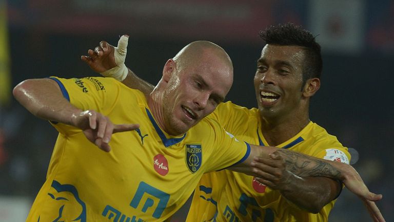 Kerala Blasters FC footballer Iain Hume (L) celebrates with team-mate Milagres Gonsalver after scoring a goal during the Indian Super League (ISL) 