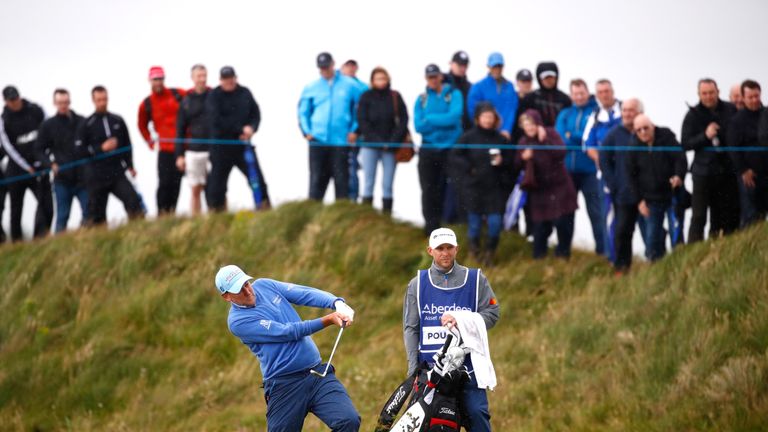 Ian Poulter hits his second shot from the edge of a bunker on the 17th at Dundonald Links