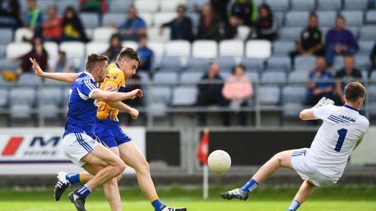 Jamie Malone of Clare shoots to score his side's first goal of the game despite the efforts of Colm Begley, left, and Graham Brody of Laois