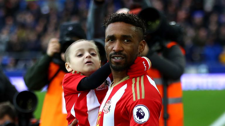 LIVERPOOL, ENGLAND - FEBRUARY 25: Bradley Lowery (L) is carried out by Jermain Defoe of Sunderland (R) prior to the Premier League match between Everton an