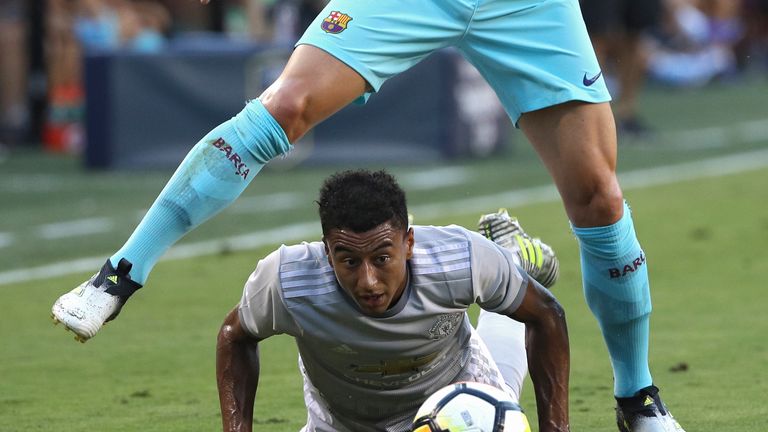 LANDOVER, MD - JULY 26: Jesse Lingard #14 of Manchester United (bottom) and Ivan Rakitic #4 of Barcelona battle for the ball in the first half during the I
