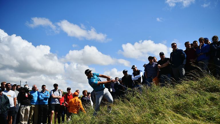Jon Rahm of Spain is watched by spectators as he plays from the rough on the 2nd hole during the first round of The Open