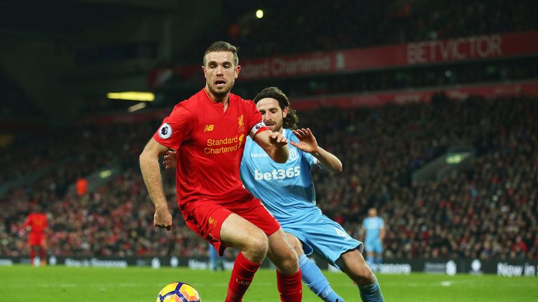 Jordan Henderson holds off Joe Allen during a Premier League match between Liverpool and Stoke City