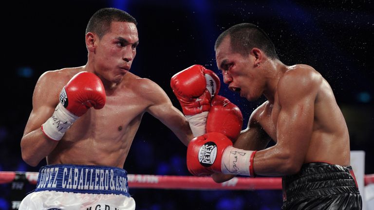 Philippines' Milan Melindo (R) competes with Mexico's Juan Francisco Estrada (L) during a WBO WBA flyweight title fight bout in Macau on July 27, 2013. 