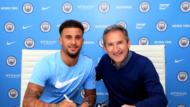 Kyle Walker pictured with Manchester City director of football Txiki Begiristain as he signs a five-year contract with the club