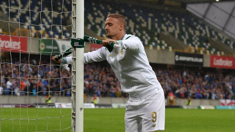 BELFAST, NORTHERN IRELAND - JULY 14: Leigh Griffiths of Celtic ties a Celtic scarf onto a goalpost which sparked crowd disorder after the Champions League 