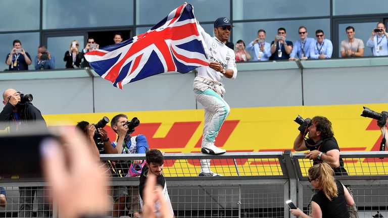 Lewis Hamilton celebrates with fans after winning the British Formula One Grand Prix at Silverstone on July 10, 2016