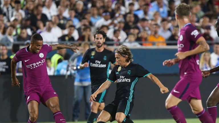 Real Madrid defender Modric (C) vies the against Manchester City's Danilo (L) during their International Champions Cup (ICC) football match on July 26, 201