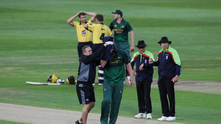 Luke Fletcher is helped off the field after being struck by a ball