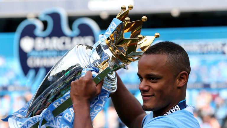 MANCHESTER, ENGLAND - MAY 13:  Vincent Kompany the captain of Manchester City poses with the trophy following the Barclays Premier League match between Man