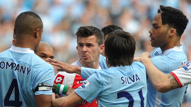 Queens Park Rangers' English midfielder Joey Barton (2nd L) clashes with Manchester City's Belgian defender Vincent Kompany (L) during the English Premier 