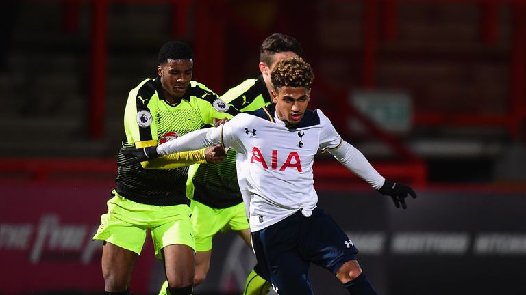 STEVENAGE, ENGLAND - MARCH 13: Marcus Edwards of Tottenham Hotspur is tackled by Ramarni Medford-Smith of  Reading during the Premier League 2 match