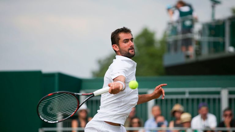 Croatia's Marin Cilic returns against Spain's Roberto Bautista Agut during their men's singles fourth round match on the seventh day of the 2017 Wimbledon 