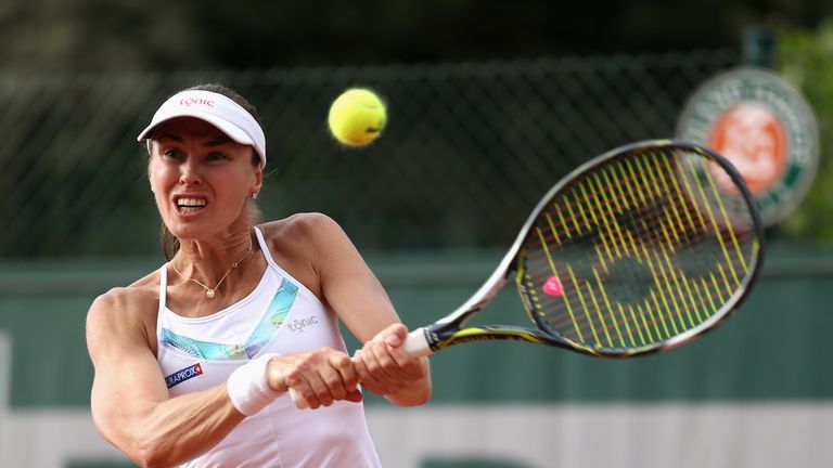 Martina Hingis of Switzerland, partner of Yung-Jan Chan of Taipei plays a forehand during the ladies doubles 