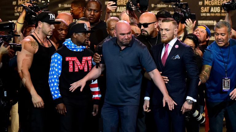 LOS ANGELES, CA - JULY 11:  Dana White, 
President of the Ultimate Fighting Championship comes between Floyd Mayweather Jr. and Conor McGregor Floyd during