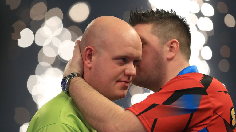 Michael van Gerwen, (left) is congratulated on his victory by Daryl Gurney