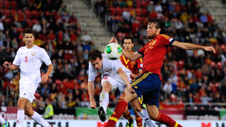 PALMA DE MALLORCA, SPAIN - OCTOBER 11:  Michu of Spain (R) shoots towards goal under a challenge by Balanovich of Belarus during the FIFA 2014 World Cup Qu
