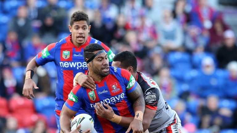 NEWCASTLE, AUSTRALIA - JUNE 11:  Mickey Paea of the Knights is tackled by the Warriors defence during the round 14 NRL match between the Newcastle Knights 