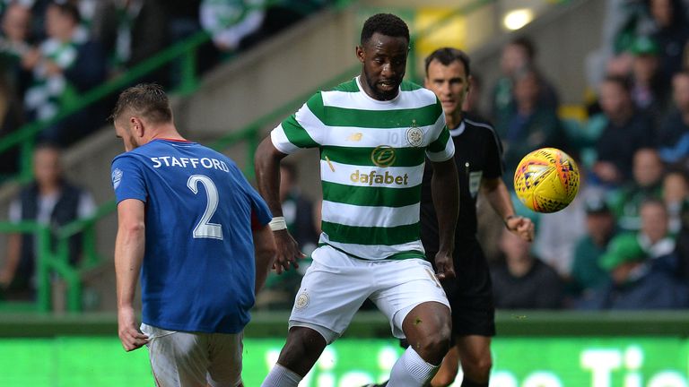 Celtic striker Moussa Dembele is challenged by Mark Stafford of Linfield