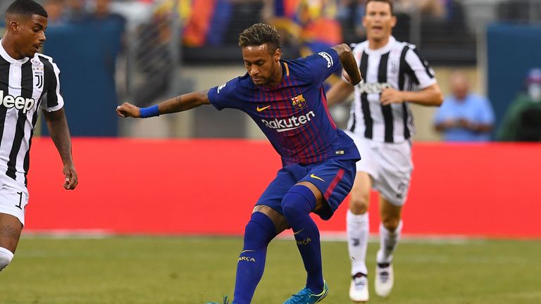 Barcelona's Brazilian forward Neymar (C) dribbles past Juventus players during the International Champions Cup (ICC) match between Juventus FC and FC Barce