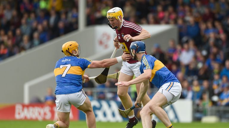 Niall Mitchell of Westmeath in action against Padraic Maher, left, and Tomas Hamill of Tipperary