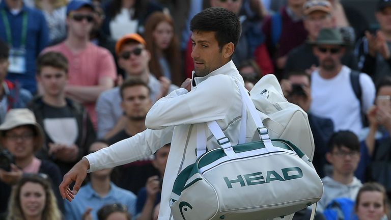 Serbia's Novak Djokovic reacts as he prepares to leave the court after retiring in his men's singles quarter-final match against returns against Czech Repu