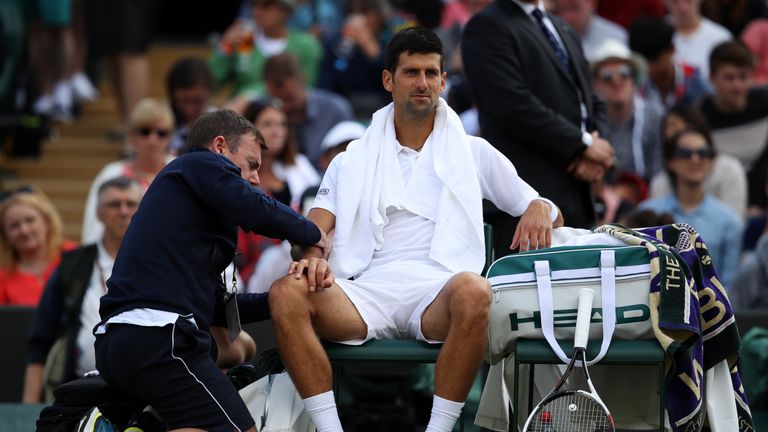 LONDON, ENGLAND - JULY 12:  Novak Djokovic of Serbia is given treatment during the Gentlemen's Singles quarter final match against Tomas Berdych of The Cze