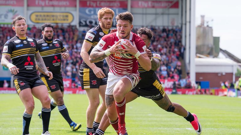 Salford's Greg Johnson cannot prevent Wigan's Oliver Gildart from scoring a try.