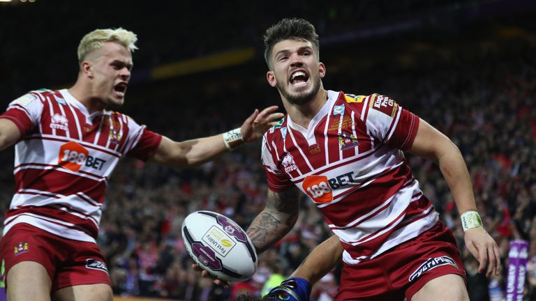 MANCHESTER, ENGLAND - OCTOBER 08:  Oliver Gildart (R) of Wigan celebrates scoring his sides opening try alongside Lewis Tierney (L) during the First Utilit