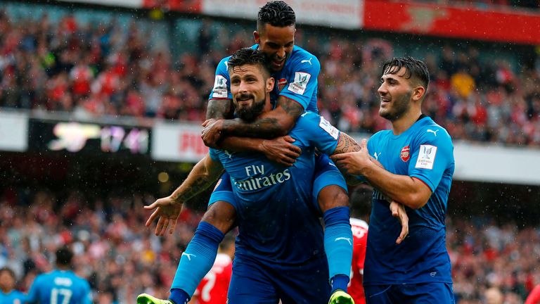 Arsenal striker Olivier Giroud celebrates with Arsenal's Theo Walcott