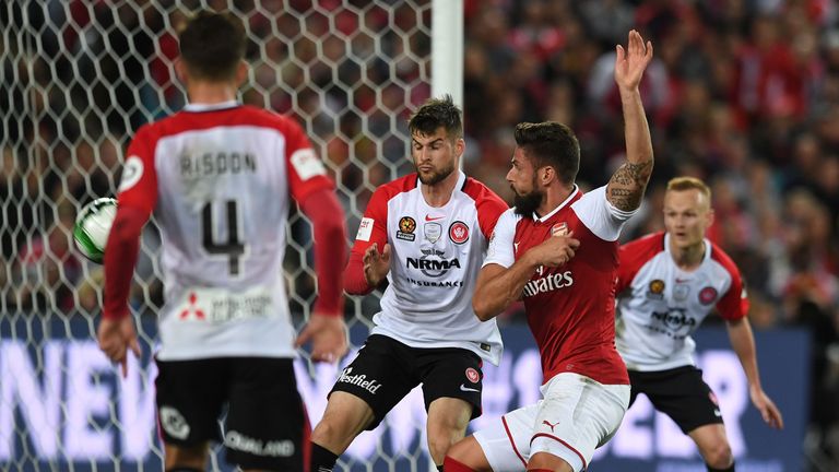 Olivier Giroud smartly turns the ball high into the net against Western Sydney Wanderers