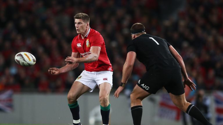 AUCKLAND, NEW ZEALAND - JUNE 24:  Owen Farrell of the Lions offloads as Joe Moody of the All Blacks closes in during the first test match between the New Z