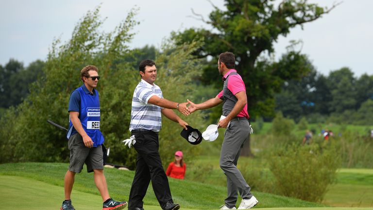 HAMBURG, GERMANY - JULY 27:   Patrick Reed of the United States and Charl Schwartzel of South Africa shake hands on the 9th green after finishing their fir