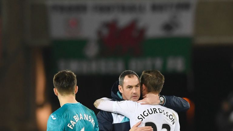 SWANSEA, WALES - JANUARY 31: Paul Clement (C), Manager of Swansea City congratulates Gylfi Sigurdsson 