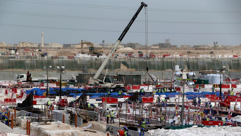 Foreign laborers work at the construction site of the al-Wakrah football stadium, one of the Qatar's 2022 World Cup stadiums, on May 4, 2015, in Doha's Al-