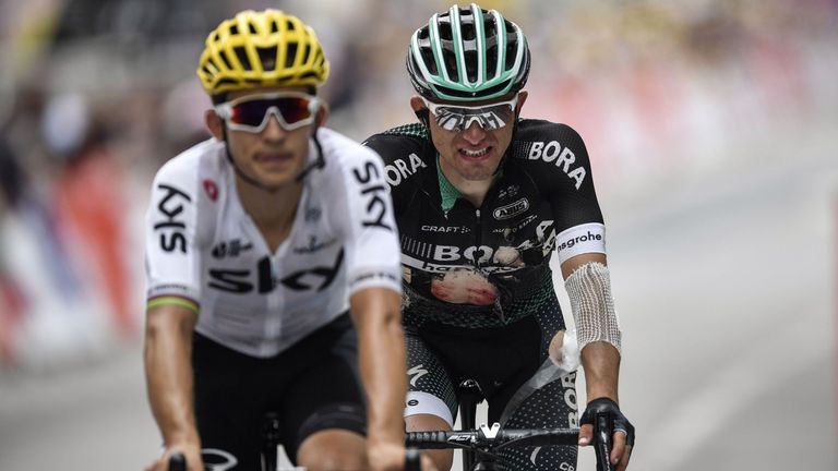 Poland's Michal Kwiatkowski (L) and Poland's Rafal Majka, injured after falling, cross the finish line at the end of the 181,5 km ninth stage of the 104th 