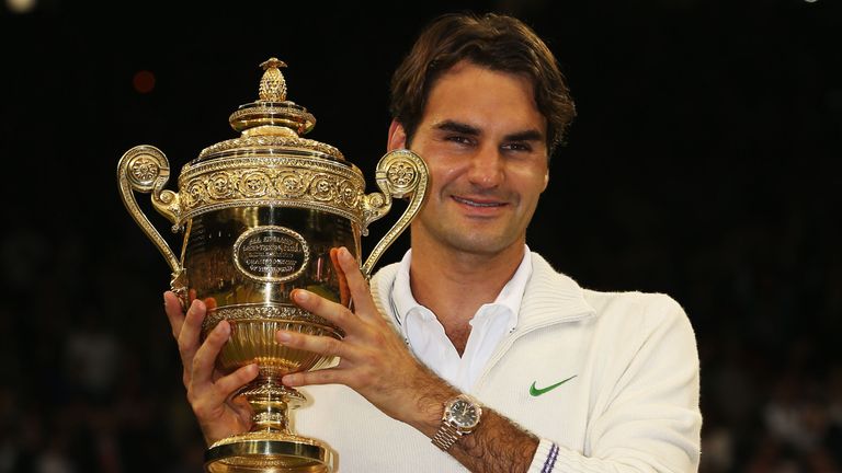 LONDON, ENGLAND - JULY 08:  Roger Federer of Switzerland holds up the winner's trophy after winning his Gentlemen's Singles final match against Andy Murray