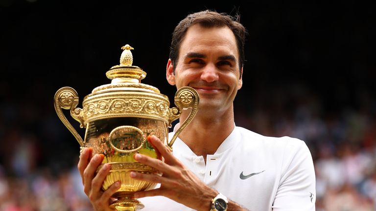 LONDON, ENGLAND - JULY 16:  Roger Federer of Switzerland celebrates victory with the trophy after the Gentlemen's Singles final against  Marin Cilic of Cro