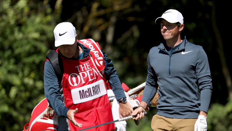 Rory McIlroy of Northern Ireland looks dejected as he hands the club to his caddie JP Fitzgerald at The Open